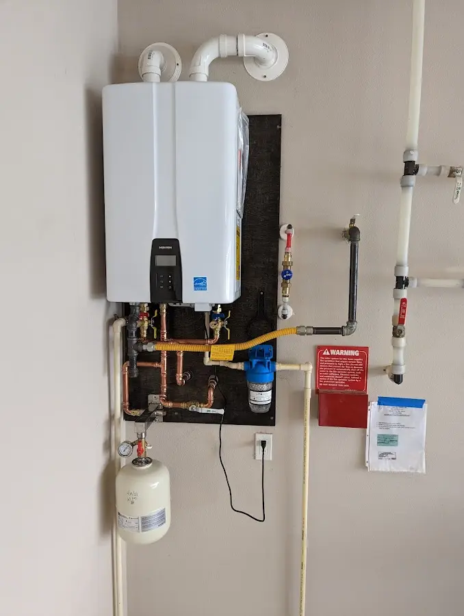 Professional plumber installing copper piping in a Crestwood home